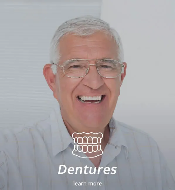 Older man smiling with dentures